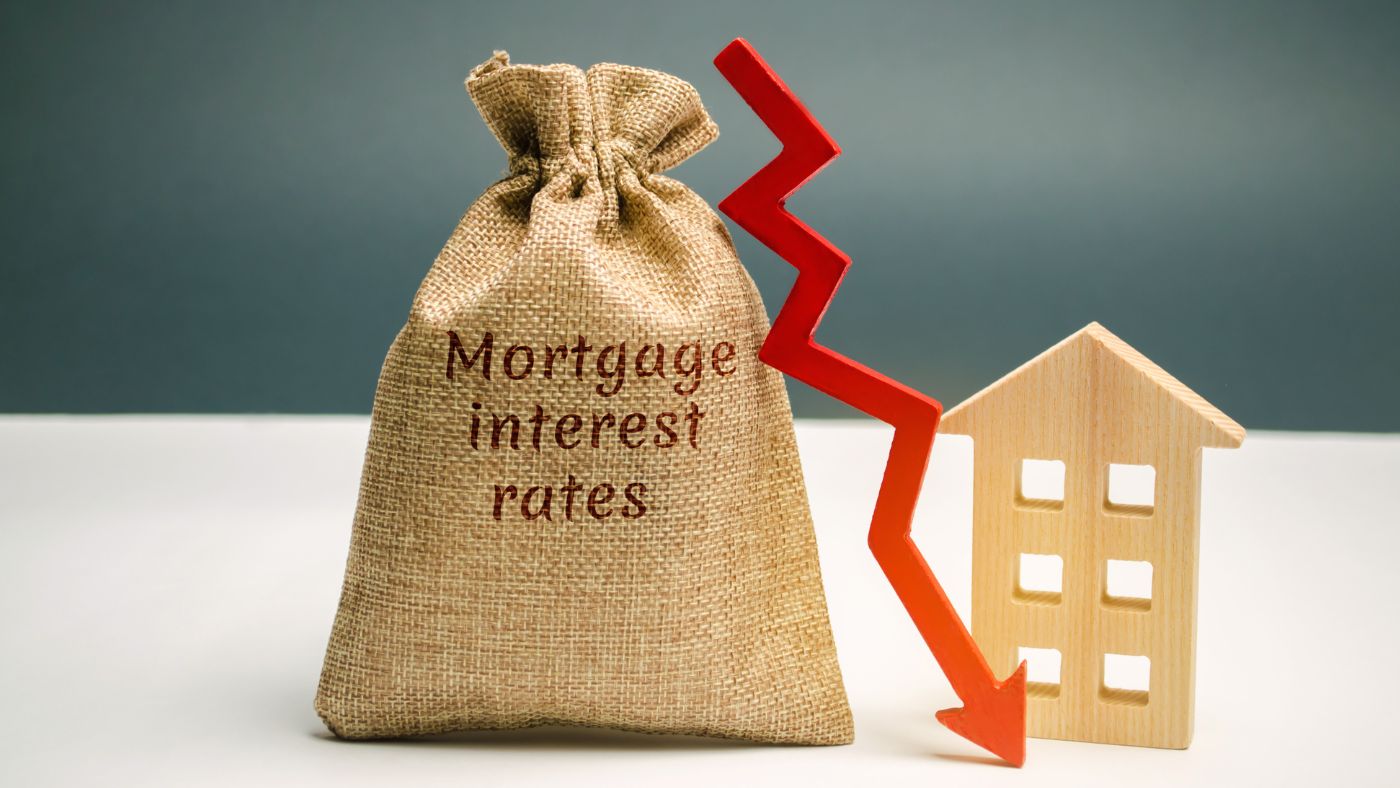 Mortgage rates 3-year low represented by money bag and downward arrow showing declining interest rates for homebuyers